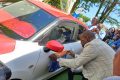 Le premier maire adjoint, Serge William Akassaga Okinda posant la première vignette. © Gabonreview