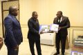 Le ministre des Travaux publics et de la Construction, Edgard Moukoumbi, recevant le document de présentation du DG d’HOMINTEC, Francis Dakato Kossi. © D.R.
