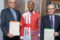 Le ministre des Eaux et Forêts, Maurice Ntossui Allogo (au milieu), posant avec deux des bénéficiaires d’attribution de Concessions, le 26 mai 2026 à Libreville. © D.R.